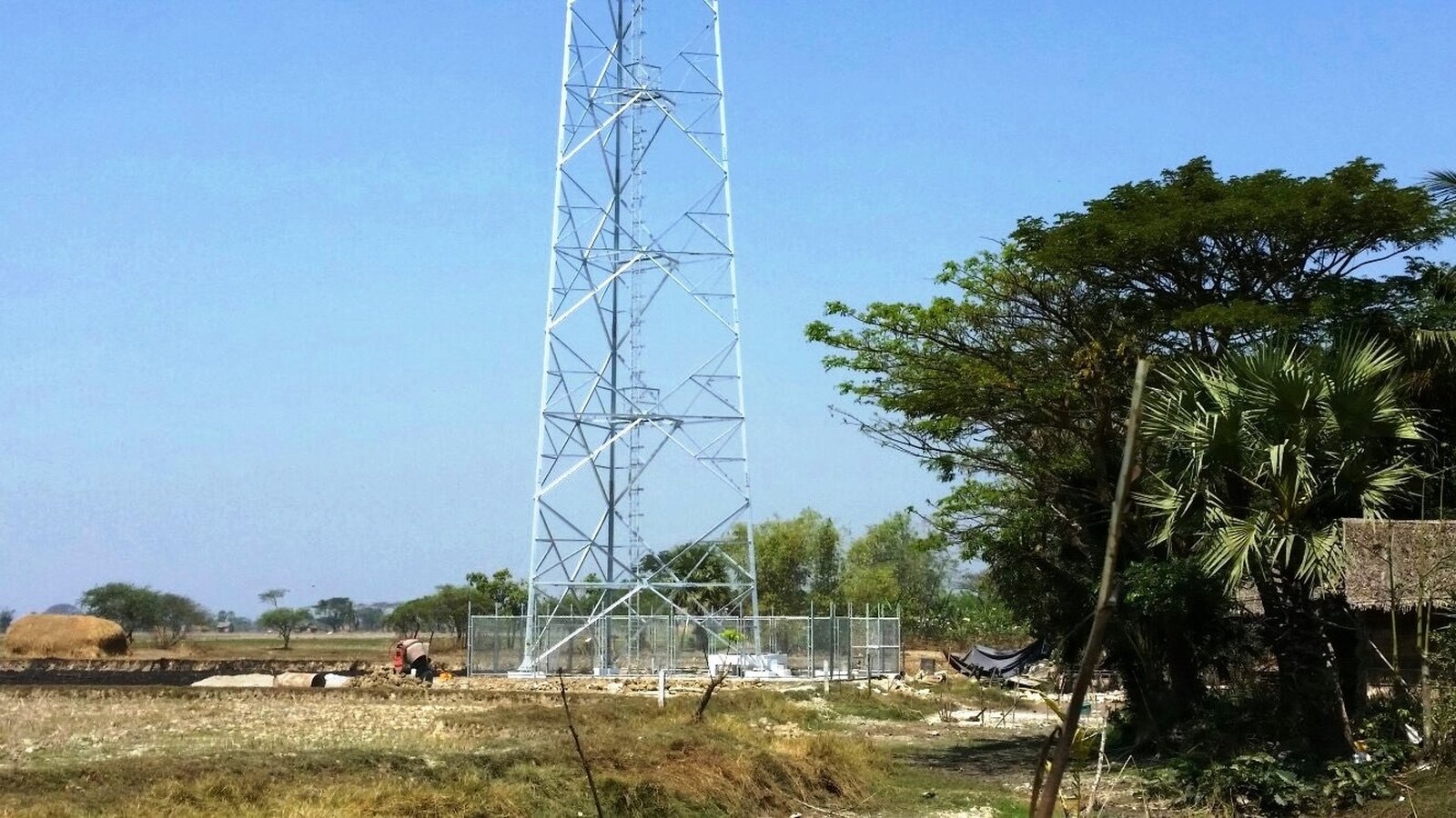 Telecommunications tower erection against sky