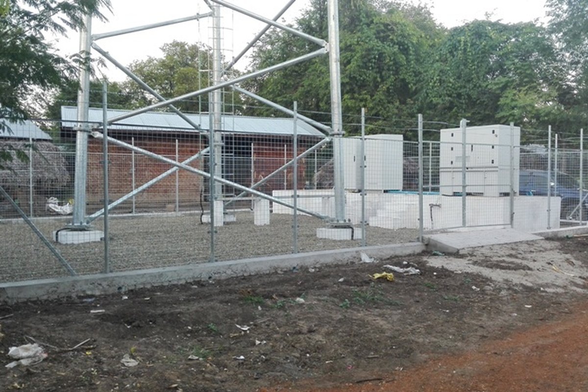 Tower site perimeter chain-link fence, gate, and clean gravel surfacing